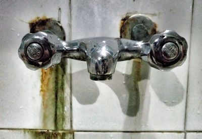 Close-up of faucet in water