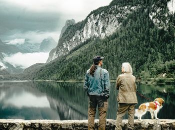 View of dogs on mountain by lake