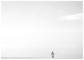 Woman standing by sea