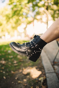 Low section of woman wearing black shoes outdoors