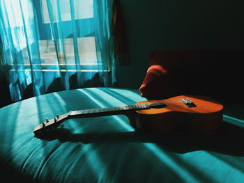 Man playing guitar at home