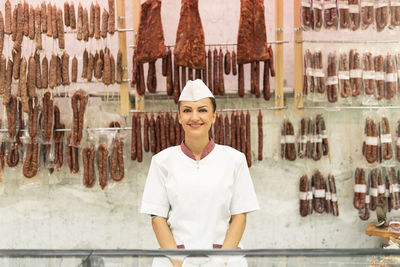 Portrait of woman working in meat shop