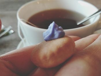 Close-up of hand holding tea cup