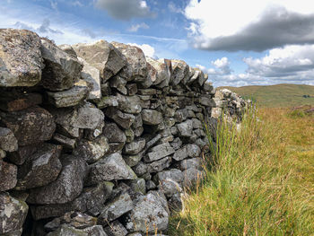Rocks on field against sky