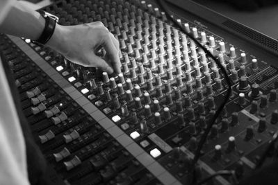 Cropped hand of musician adjusting audio equipment