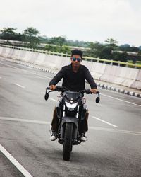 Man riding motorcycle on road