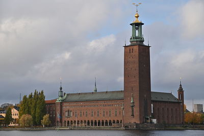 Tower amidst buildings in city against sky