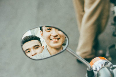 Portrait of a smiling young man with reflection