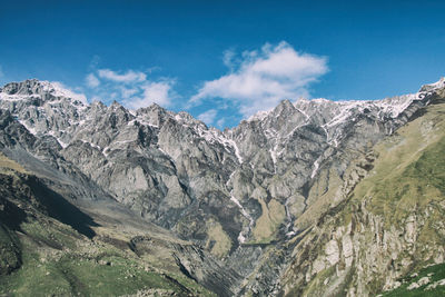 Scenic view of mountains against blue sky