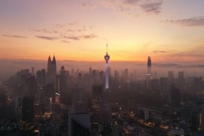 Buildings in city during sunset