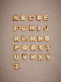 High angle view of baked alphabet cookies on table