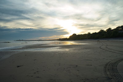 Scenic view of beach against sky during sunset