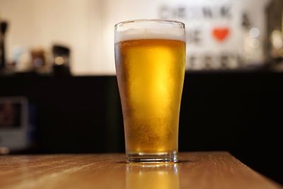 Close-up of beer glass on table