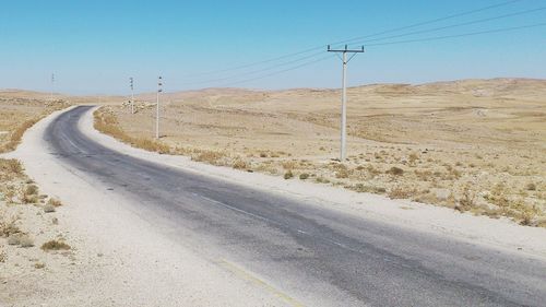 Road passing through land against sky