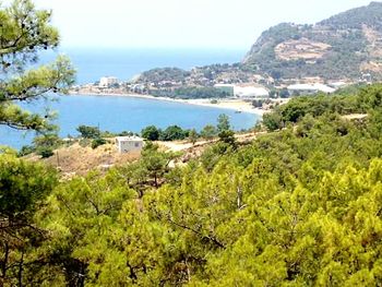 Scenic view of sea and mountain against sky