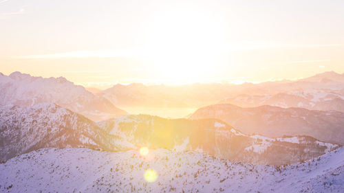 Scenic view of snowcapped mountains against sky during sunset