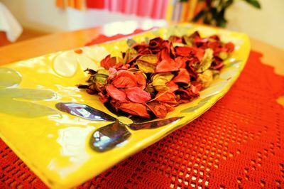 High angle view of chopped fruits in plate on table