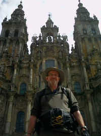 Low angle portrait of man standing against building