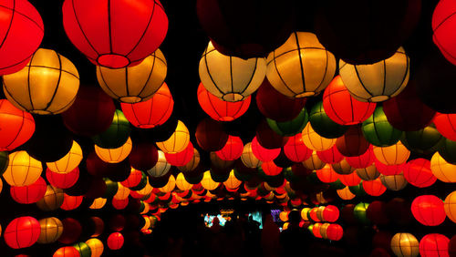 Low angle view of illuminated chinese lanterns hanging at night