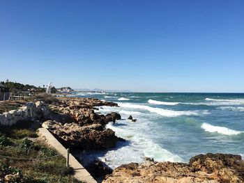 Scenic view of sea against clear blue sky