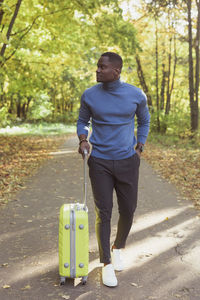 Rear view of man walking on road