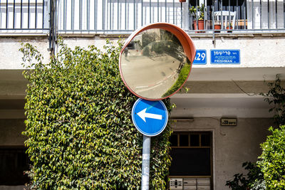 Low angle view of road sign in city