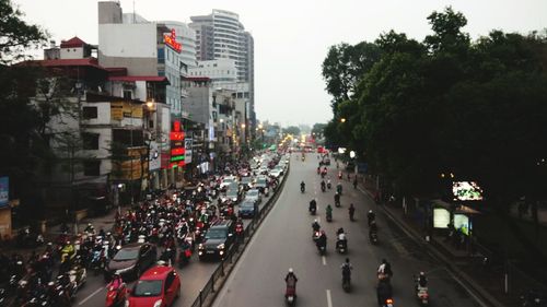 Panoramic view of crowd in city against sky