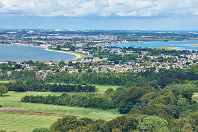 High angle view of cityscape and sea against sky