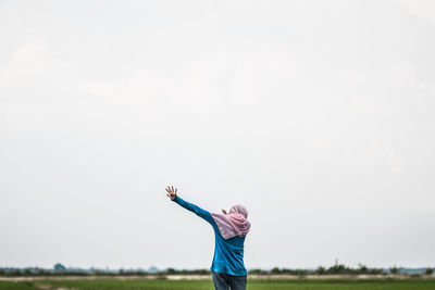 Person on field against clear sky