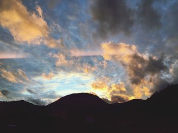 Scenic view of mountains against cloudy sky