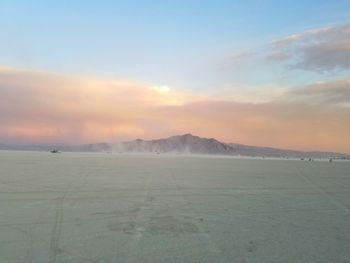 Scenic view of field against sky during sunset