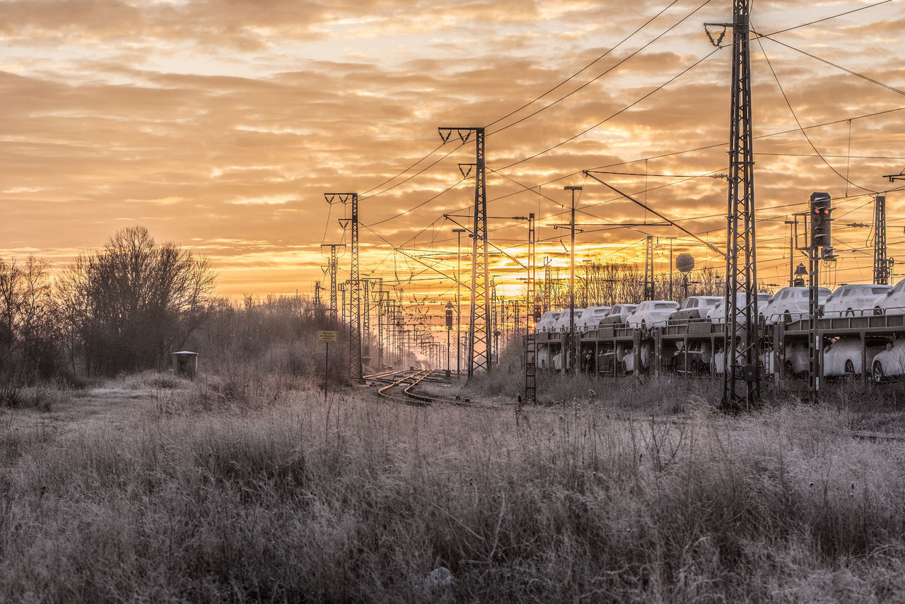 ELECTRICITY PYLON ON FIELD DURING SUNSET