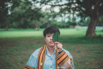 Portrait of boy wearing sunglasses on field