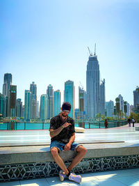 Buildings in city against clear sky