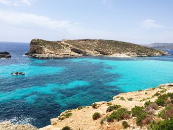 Scenic view of sea against blue sky