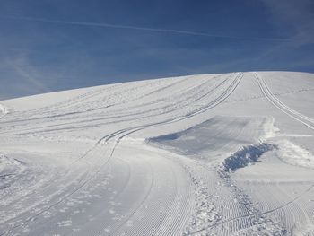 Snow covered land against sky