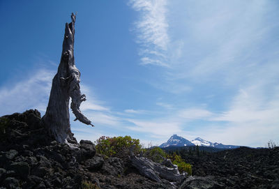 Traditional windmill on mountain against sky