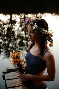 Side view of woman holding flower bouquet