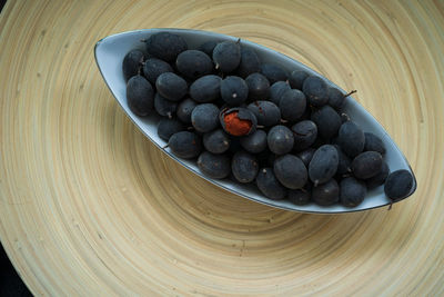 High angle view of blueberries in bowl on table