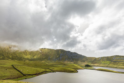 Clouds swirl above the rim of the corvo crater on the island of corvo in the azores, portugal.