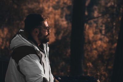 Man looking away in forest