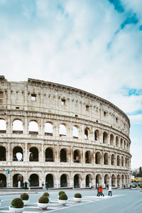 View of coliseum against cloudy sky