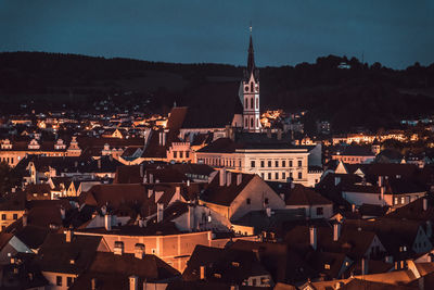 Illuminated cityscape against sky at night