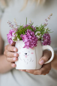 Midsection of woman holding bouquet