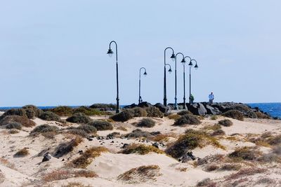 Scenic view of rocks on beach against sky