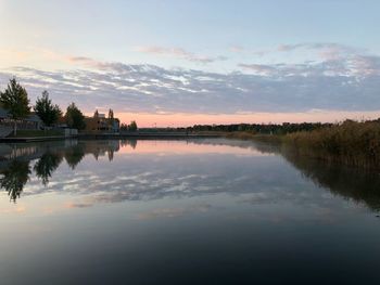 Scenic view of lake against sky at sunset