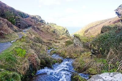 Scenic view of waterfall against sky