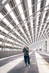 Rear view of man standing on footpath