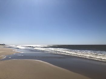 Scenic view of beach against clear sky