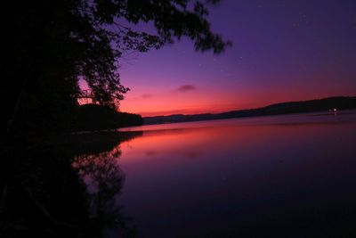 Scenic view of river against sky at dusk